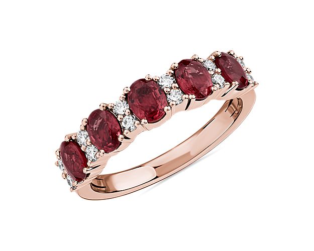 Elegant in design, this ring features five striking rubies accented with rows of brilliant diamonds set in 14k rose gold.