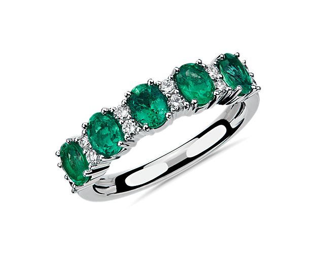Elegant in design, this ring features five striking emeralds accented with rows of brilliant diamonds set in 14k white gold.