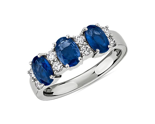 Elegant in design, this ring features three vivid blue sapphires accented with rows of brilliant diamonds set in 14k white gold.