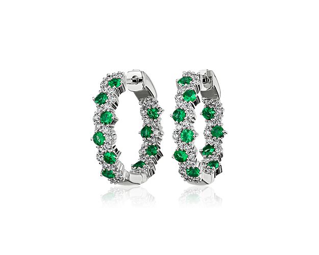 Delicate in design, elegant in form, this masterfully crafted emerald and diamond hoop earring features brilliant round emeralds fashioned into a contemporary garland design set in 14k white gold.