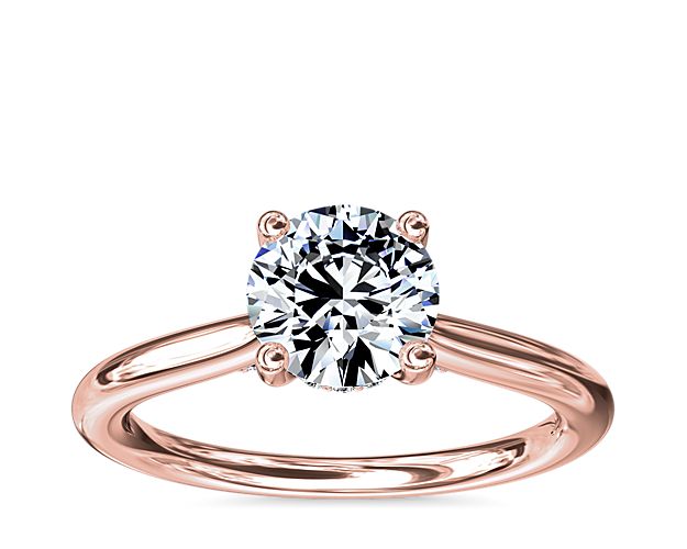 Classic from a bird's-eye view, this 14k rose gold solitaire has a delicate diamond profile and slight cathedral that put your center stone on display.
