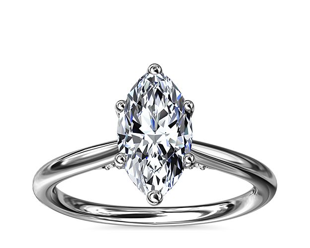 Classic from a bird's-eye view, this 14k white gold solitaire has a delicate diamond profile and slight cathedral that put your center stone on display.