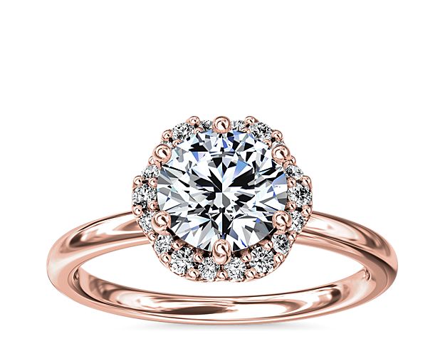 In stunning 14k rose gold, this six-prong setting supports your choice of center stone while the delicate floral halo surrounds it, accentuating its beauty.