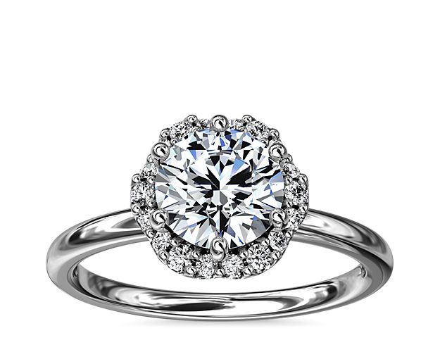 In stunning 14k white gold, this six-prong setting supports your choice of center stone while the delicate floral halo surrounds it, accentuating its beauty.