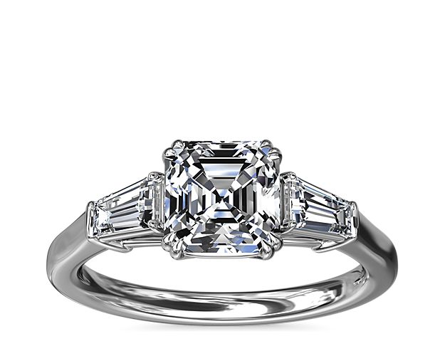 A timeless symbol of love and beauty, this platinum engagement ring marries Art Deco-inspired style with pure elegance as twin tapered baguette diamonds frame a center stone casting their everlasting light in every direction.