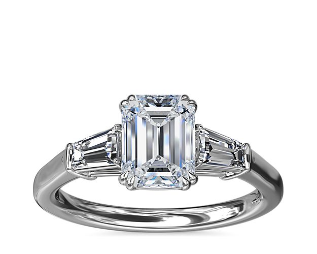 A timeless symbol of love and beauty, this platinum engagement ring marries Art Deco-inspired style with pure elegance as twin tapered baguette diamonds frame a center stone casting their everlasting light in every direction.