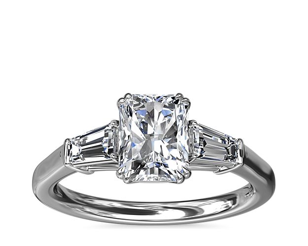 A timeless symbol of love and beauty, this platinum engagement ring marries Art Deco-inspired style with pure elegance as twin tapered baguette diamonds frame a center stone casting their everlasting light in every direction.