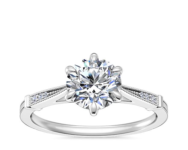 Express your enduring love with this stunning engagement ring beautifully crafted from 14k white gold. The six-prong design is gorgeously framed by milgrain detail and accent diamonds for an elegant vintage-inspired look that promises plenty of sparkle.