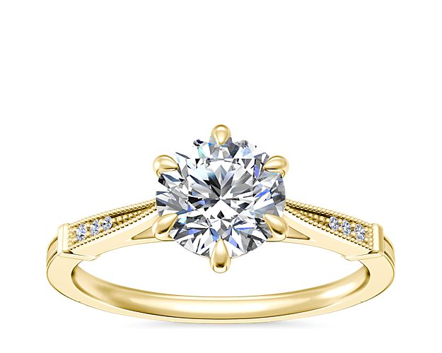 Let your love shine with this beautiful engagement ring featuring delicate milgrain detail and accent diamonds along the shank to frame the center stone with vintage-inspired allure. The lustrous 14k yellow gold design features six prongs to elegantly hold the center stone secure.