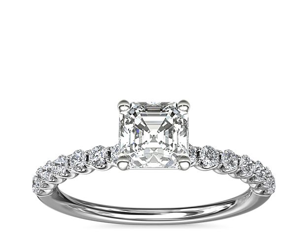 Express your love with this timeless Selene engagement ring that highlights your chosen center stone in a gleaming platinum setting. The U-shaped profile features a shimmering array of accent diamonds along the band.