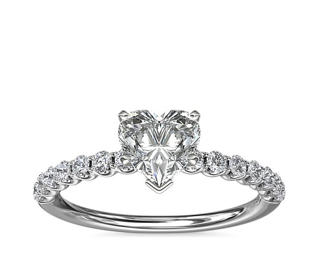 Express your love with this timeless Selene engagement ring that highlights your chosen center stone in a gleaming platinum setting. The U-shaped profile features a shimmering array of accent diamonds along the band.