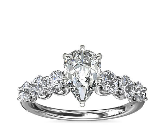 A timeless symbol of love, this Selene engagement ring features a luminous platinum setting lined with six round accent diamonds to create a stunning U-shaped profile that complements your center stone.