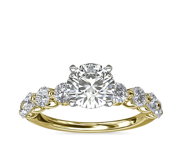 A floating center stone summons the eye to this decadent engagement ring, while eight round accent diamonds form a breathtaking backdrop. The 14k yellow gold setting brings luxurious warmth to this classic ring.
