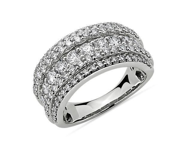 Indulge in the opulent design of this 14k white gold ring set with three rows of round diamonds in varied sizes that catch the light from every angle.