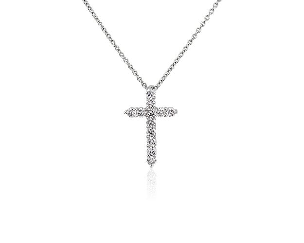 A brilliant expression of faith, this 14k white gold cross pendant necklace beams brightly with diamonds encrusted all over its surface.