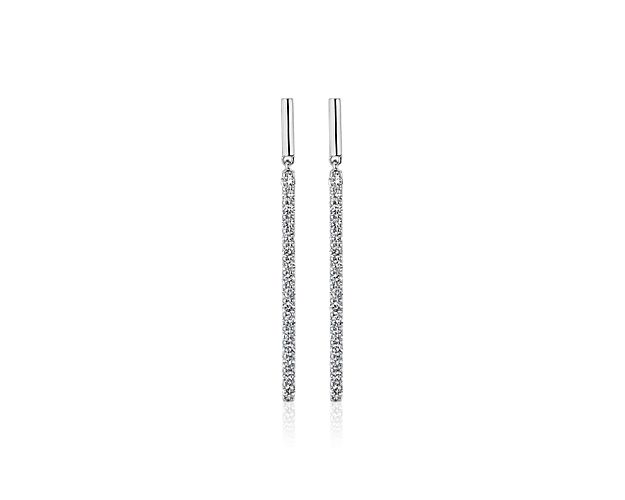 Channel set stones illuminate the face of these 14k white gold drop earrings giving their bold minimalist bar design a dash of glamorous sparkle.
