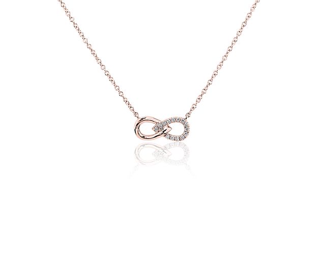 Delight in the infinite sparkle of this lemniscate-shaped pendant crafted from 14k rose gold and offset by string of demure round diamonds.