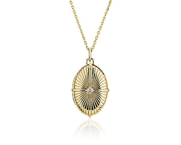 Delight in the celestial sparkle of this 18k yellow gold locket designed with a textural starburst radiating from a demure diamond at the center of its face.