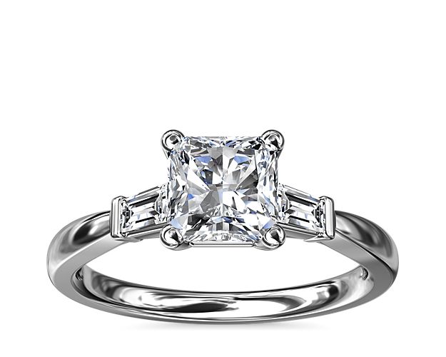Classic and timeless, this engagement ring features two dazzling tapered baguettes that frame your choice of center stone beautifully.