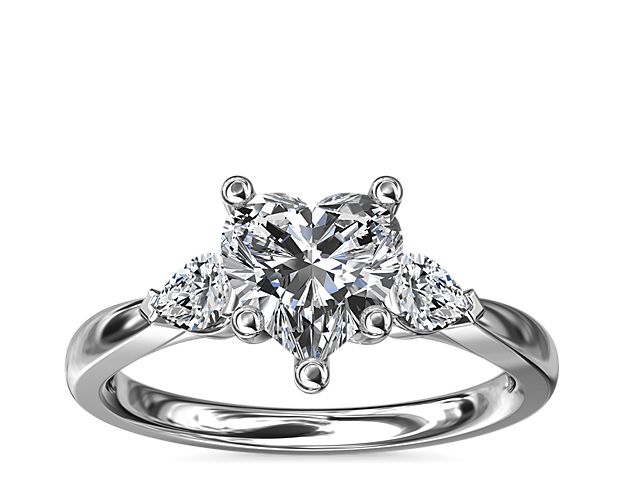 A bright white gold setting embraces your precious diamond while pear-shaped side stones add a fancy-cut edge.