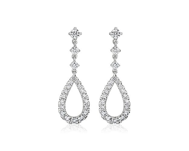 Bright, white gold and diamonds are composed in elegant harmony to create these dramatic teardrop earrings.