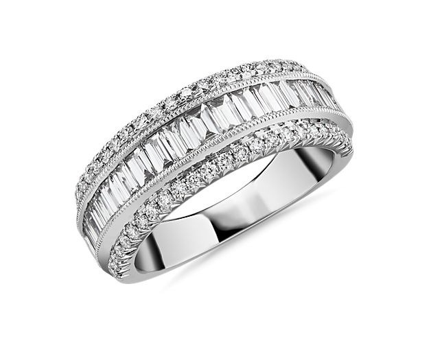 Celebrate everlasting love with this stunning wedding ring crafted from luxurious 14k white gold and boasting a breathtaking 1 1/2 ct. tw. in shimmering diamonds. The band features a gleaming row of baguette-cut diamonds accentuated by a row of pavé-set diamonds on either side.