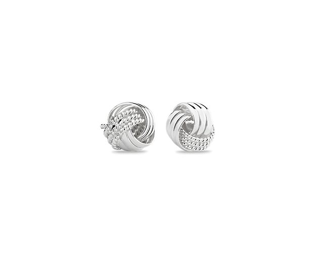 Heartfelt and feminine, these trio love knot stud earrings are intricately crafted from hollow links in polished sterling silver with subtly textured accents. Their petite size is great for everyday wear, and they make a classic addition to any look.