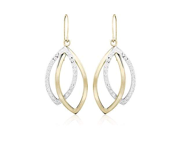 These two-tone teardrop dangle earrings go with virtually everything. Open teardrops of 14k white and yellow gold are secured together and dangle gently from a slim ear wire for a look that epitomizes everyday elegance.
