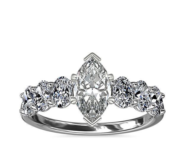 Love shines bright in this beautiful platinum and diamond engagement ring. Beset with a row of sparkling oval diamonds this design will showcase your choice of center beautifully,