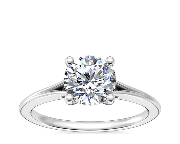 Polished platinum hosts a shimmering diamond in a four-prong setting on this solitaire ring. A split shank band highlights the stone while simultaneously adding depth.