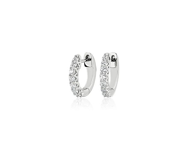 Go for stunning style when you wear these gorgeous Tessere style hoop earrings featuring an artfully entwining 14k white gold design that gracefully holds a row of brilliant diamonds along the edge.