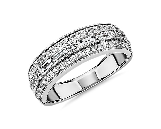Delight in designer sparkle made to last a lifetime as milgrain trim, and two outer rows of round pavé diamonds soften the geometric design of this 14k white gold wedding ring featuring a center channel of baguette diamonds.