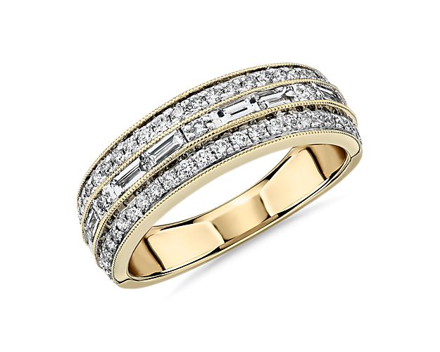 Delight in designer dazzle made to last a lifetime as milgrain trim, and two outer rows of round pavé diamonds add romance to the geometric design of this 14k yellow gold wedding ring featuring a center channel of baguette diamonds.