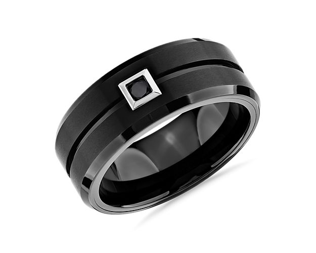 This scratch resistant, comfort fit wedding ring features durable black tungsten carbide and an enduring 1/10 carat single black diamond for a look that promises strength and style.