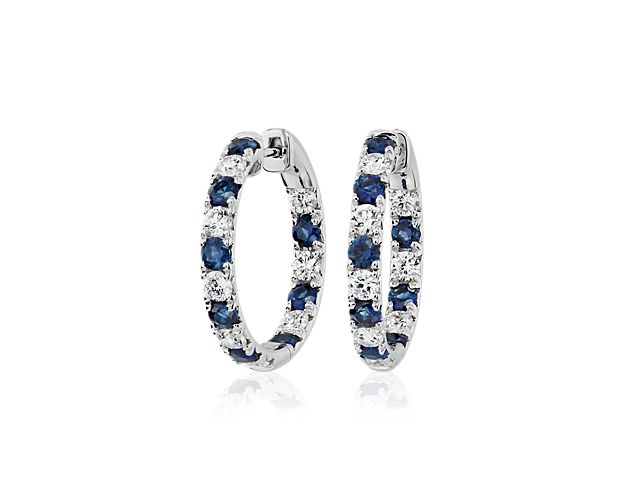 A captivating hoop of alternating inside out French pave sapphires and diamonds make a timeless statement when set in these 14k white gold earrings.