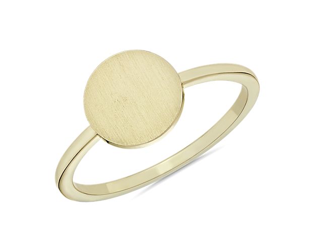 This charming 14k yellow gold ring features a smooth disc and delicate design. A lovely touch. Please note: this ring style is not engravable.