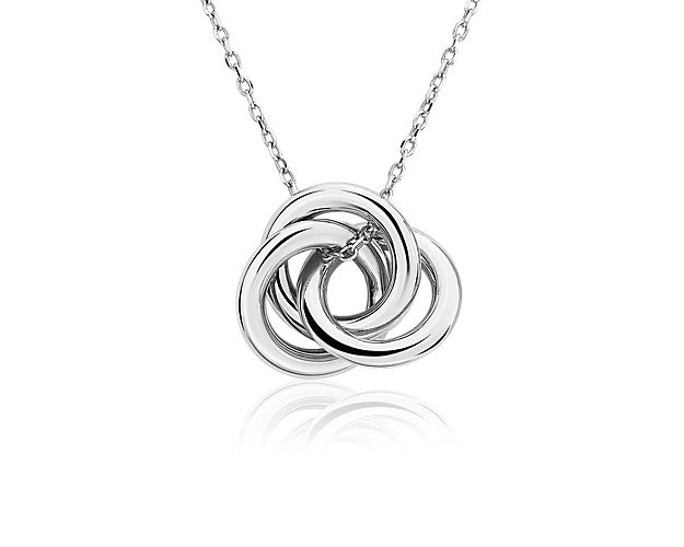 Three intertwined 14k white gold rings form a love knot and are suspended from a cable chain to create a unique and modern design.