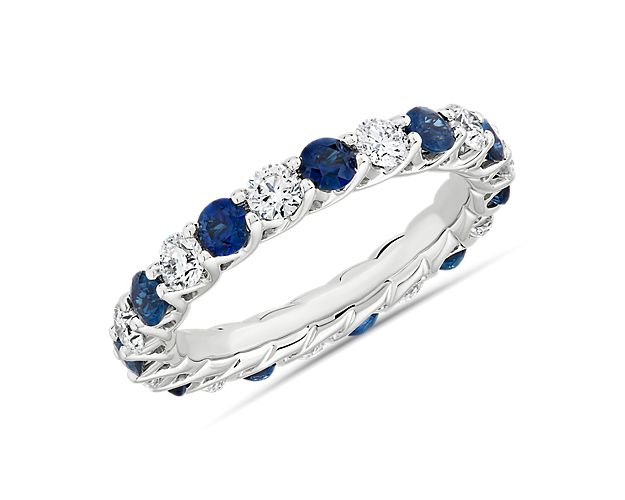When you're looking for something a little different, deep toned blue sapphires and round-cut diamonds nestle together along this 14k white gold eternity band.
