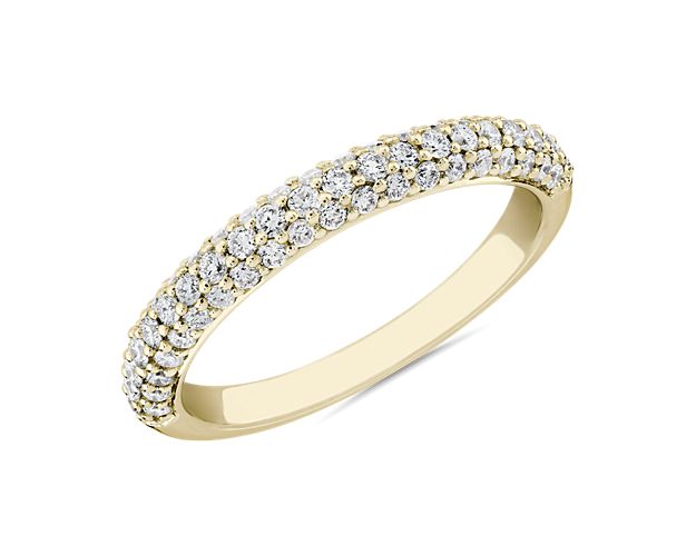 The soft curve of this anniversary ring hosts three rows of pave diamonds set into 14k yellow gold which effortlessly adds to the shine.