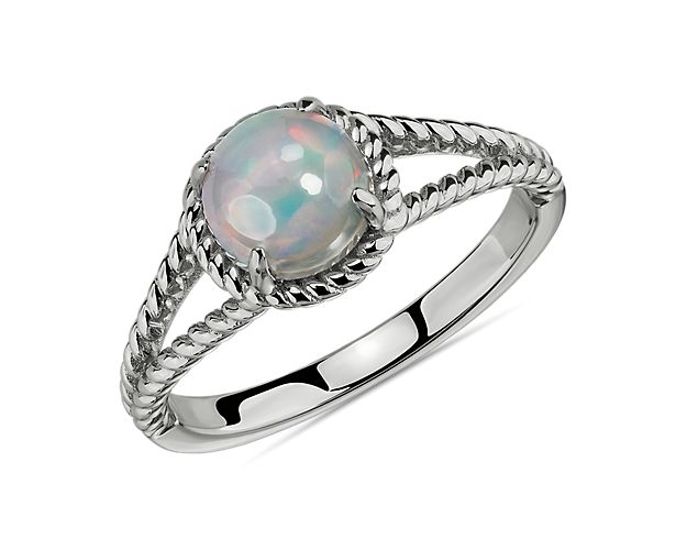 Utterly wearable, this opal rope ring is crafted in polished sterling silver. A single vibrant, translucent opal gemstone is framed by classic rope details creating an iconic, colorful ring. While perfect for any look, opals are a softer gemstone and not recommended for daily wear.