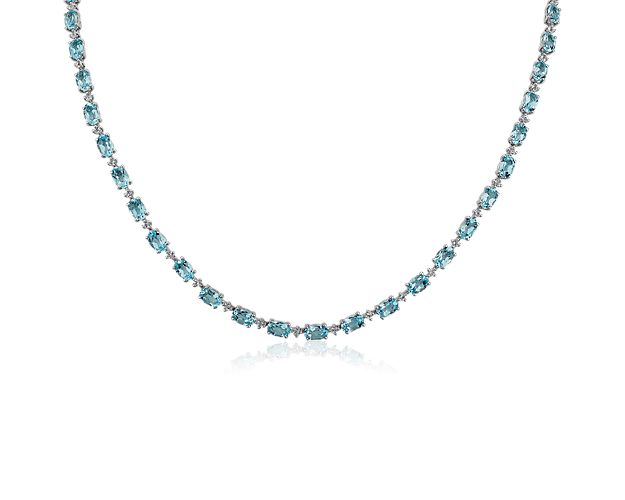 Soft angles and clean lines blend to create the beautiful clarity of this sterling silver necklace as oval blue topaz elegantly curve around the decolletage emitting their pale blue light.