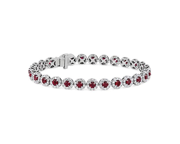 Regal splendor radiates from every angle of this 14k white gold bracelet as strings of round rubies surrounded by delicate diamond halos are set next to one another in a breathtaking display of craftsmanship.