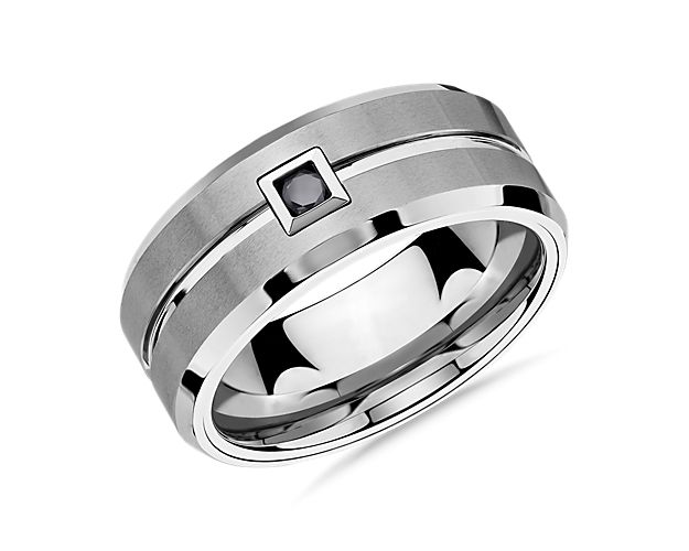 This scratch resistant, comfort fit wedding ring features durable white tungsten carbide and an enduring 1/10 carat single black diamond for a look that promises strength and style.
