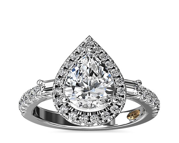 Opulent, vintage, and brilliant, your choice of pear center stone is framed by a diamond halo and two baguette sidestones.