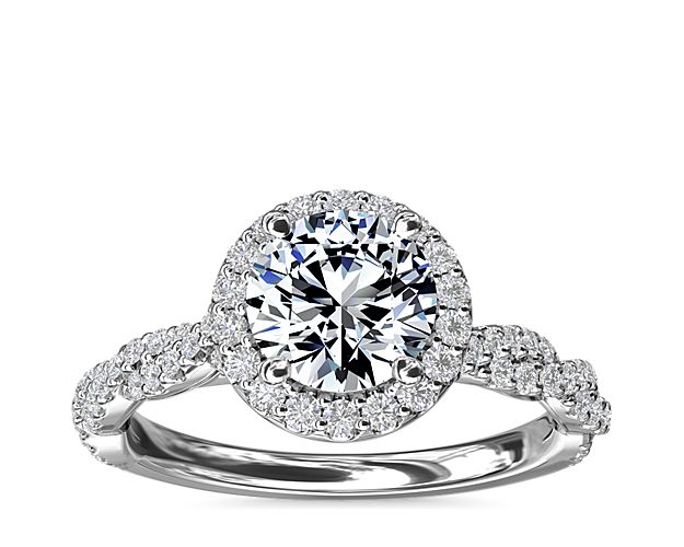This diamond engagement ring puts a twist on the classic halo - a twisted diamond band - to create a look that's traditional yet modern.