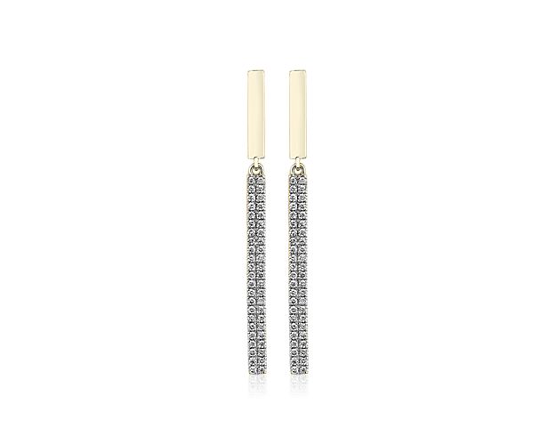 Dangling diamonds brighten your profile on these trendy drop bar earrings made from warm 14k yellow gold.