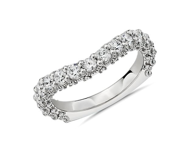 Opt for breathtaking style with this curved wedding ring featuring a shimmering 1 1/4 ct. tw. of round-cut diamonds catching the light. It features luxurious platinum design with intricate milgrain detail, and a curved shape that nestles beautifully next to its perfect match, engagement ring stock number 77072.