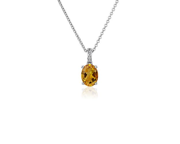 Inspire second glances when you wear this beautifully sparkling oval citrine pendant featuring elegant diamonds pavé-set along the bail. The classic four-prong setting and cable chain are artfully crafted from white gold.