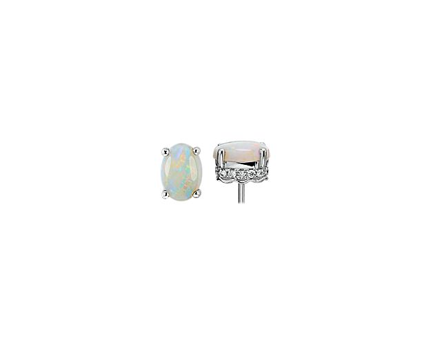 You’ll be sure to mesmerize whenever you wear these stunning stud earrings featuring shimmering oval-cut opals. The four-point white gold setting is accented by a row of pavé diamonds that catch the light as you move.