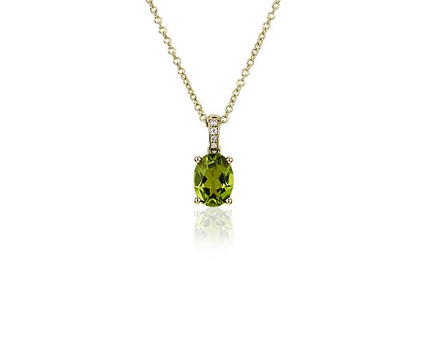 Summon second glances when you wear this stunning pendant featuring a lively green oval peridot nestled in a four-prong yellow gold setting. A trail of pavé-set diamonds accent the bail as it reaches to meet the cable chain.